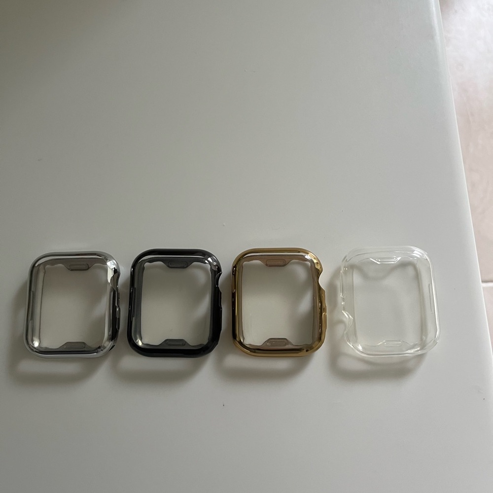 Set of 4 Watch Cases in Silver, Black, Gold, and Clear